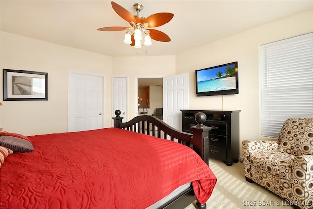 bedroom with light colored carpet and a ceiling fan