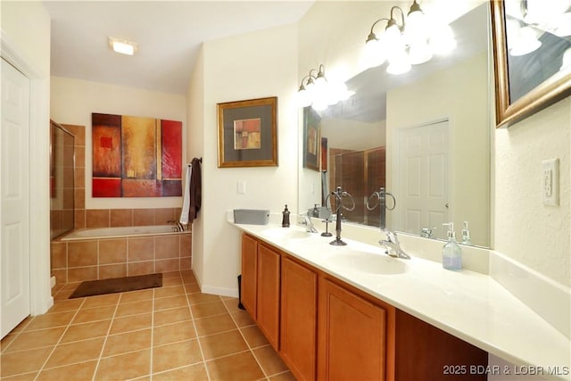 full bathroom featuring tile patterned floors, a tile shower, a garden tub, and a sink