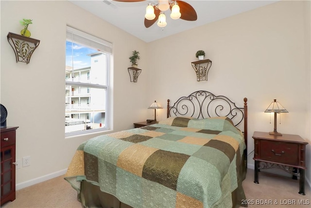 carpeted bedroom with baseboards and a ceiling fan