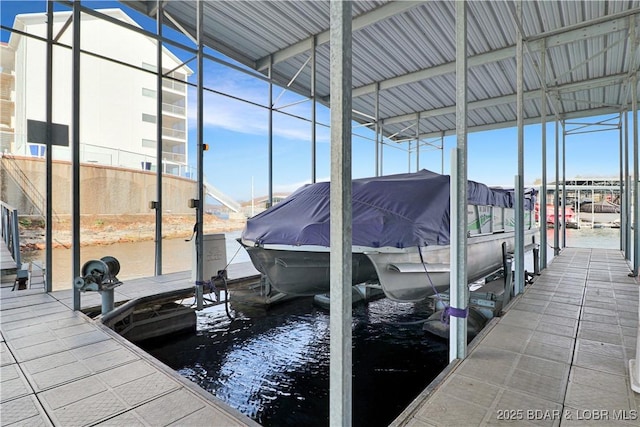 dock area with a water view and boat lift