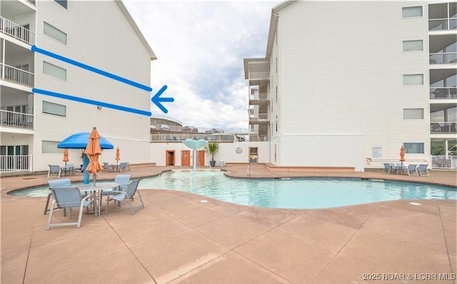 community pool with a patio area