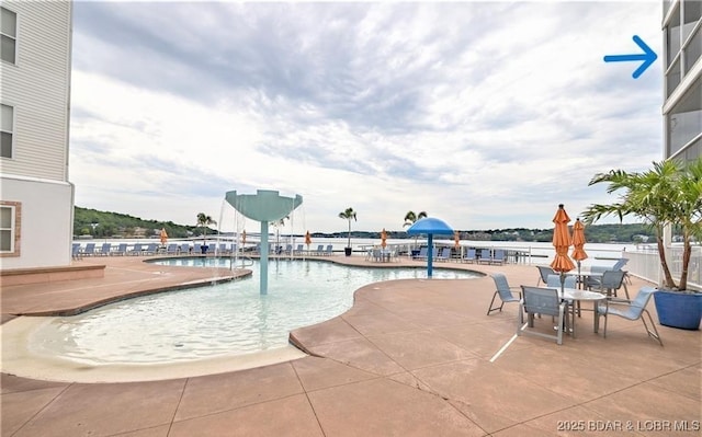 community pool with a patio area