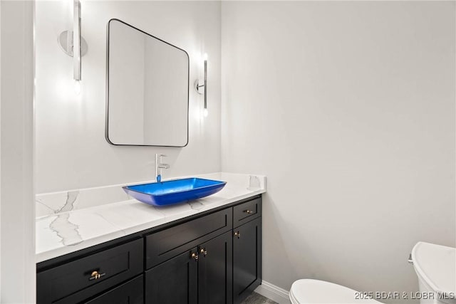 bathroom featuring vanity and toilet