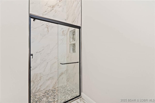 bathroom featuring a shower with shower door