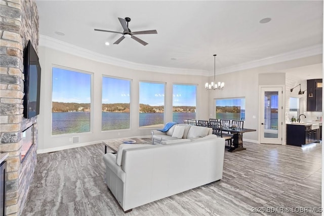 1536 Shootout Dr, Osage Beach, MO 65065 - living room with a ceiling fan, a chandelier, crown molding, a fireplace, and baseboards