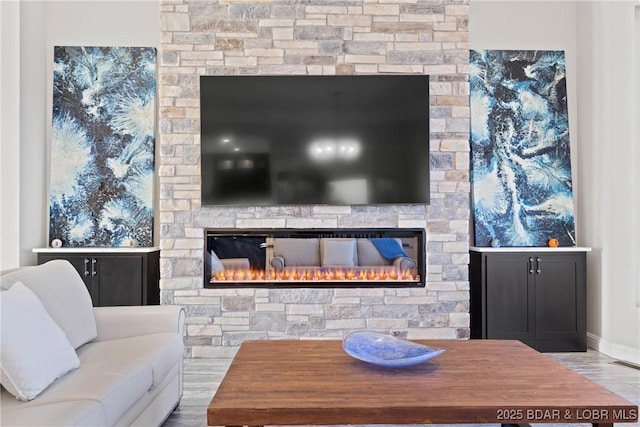 living room featuring light hardwood / wood-style floors and a fireplace