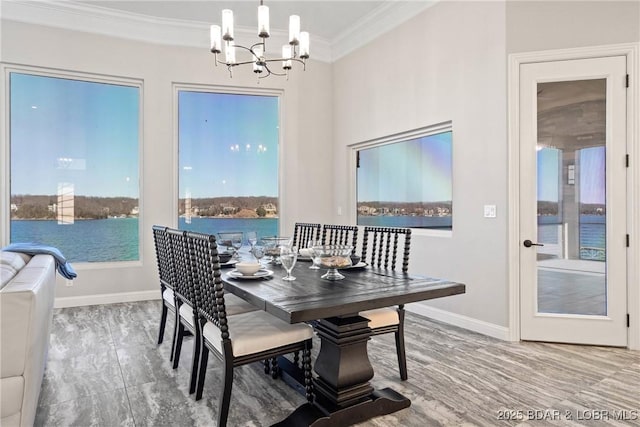 1536 Shootout Dr, Osage Beach, MO 65065 - dining room featuring crown molding, a chandelier, baseboards, and a water view