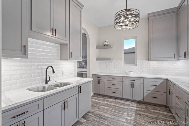 1536 Shootout Dr, Osage Beach, MO 65065 - kitchen with gray cabinets, a sink, open shelves, and light stone counters