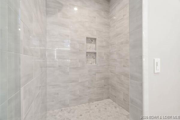 bathroom with a tile shower