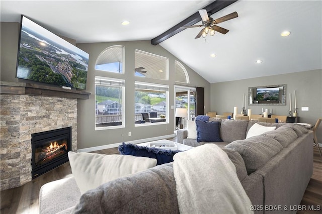 living room with beamed ceiling, dark hardwood / wood-style flooring, high vaulted ceiling, and a stone fireplace