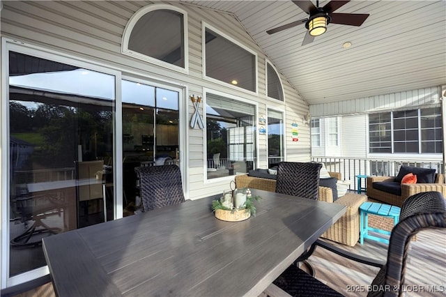 sunroom / solarium featuring lofted ceiling and ceiling fan