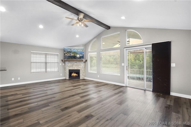 unfurnished living room featuring a wealth of natural light, vaulted ceiling with beams, dark wood-type flooring, and a fireplace