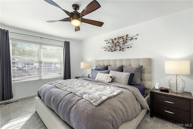 bedroom featuring light carpet and ceiling fan