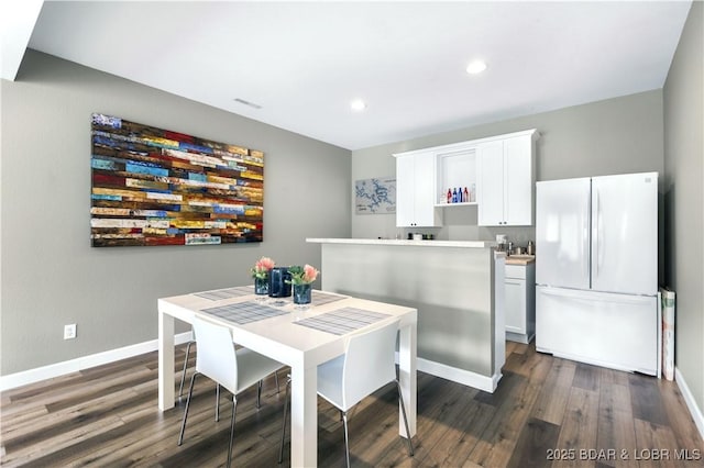 dining space featuring dark hardwood / wood-style flooring