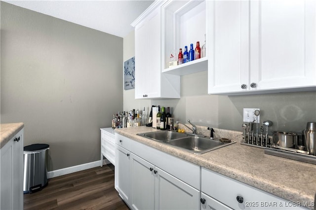 kitchen featuring white cabinetry, sink, and dark hardwood / wood-style floors