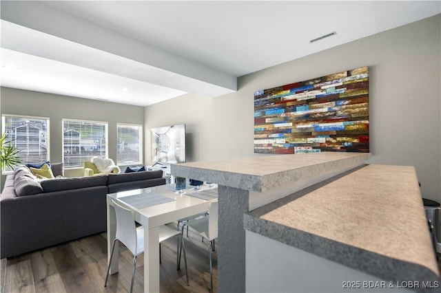 dining space with dark wood-type flooring