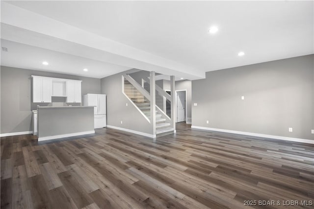 unfurnished living room with dark wood-type flooring