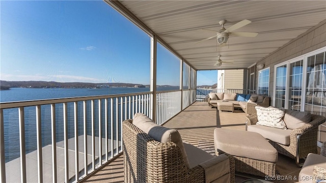 unfurnished sunroom with a water view and ceiling fan