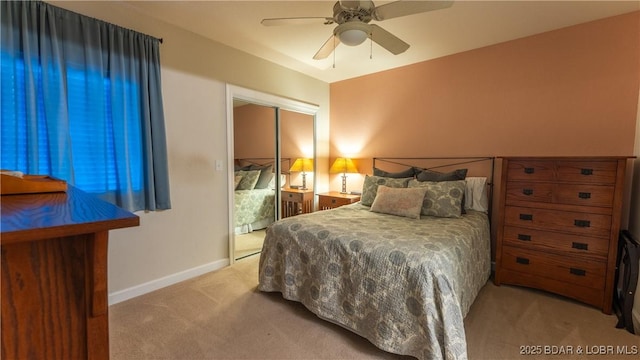 bedroom featuring ceiling fan, light carpet, and a closet