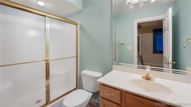 bathroom with vanity, toilet, and a shower with shower door