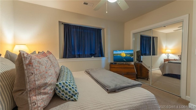 bedroom with ceiling fan, a closet, and carpet floors