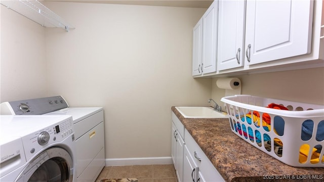 laundry area with cabinets, independent washer and dryer, sink, and light tile patterned floors