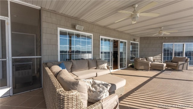 sunroom / solarium featuring ceiling fan