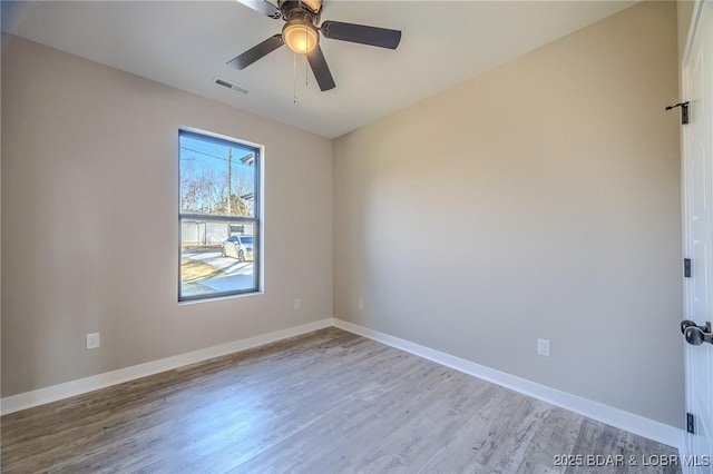 spare room with light wood-type flooring and ceiling fan