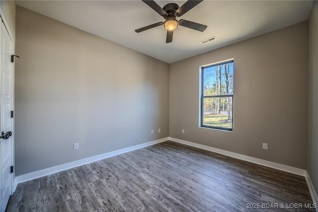 unfurnished room with ceiling fan and dark hardwood / wood-style flooring