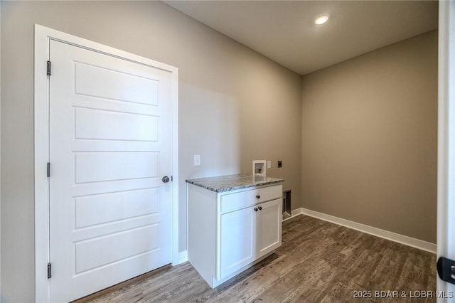 clothes washing area with hookup for an electric dryer, hookup for a washing machine, dark hardwood / wood-style flooring, and cabinets