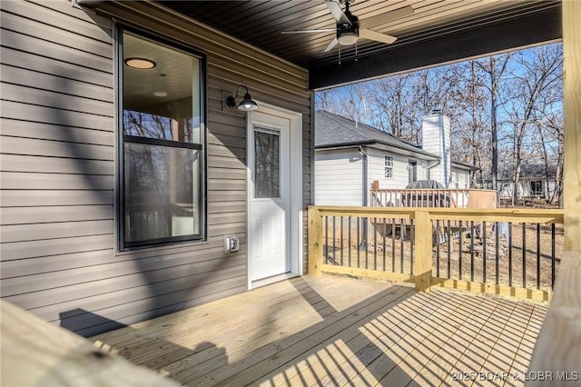 wooden terrace featuring ceiling fan