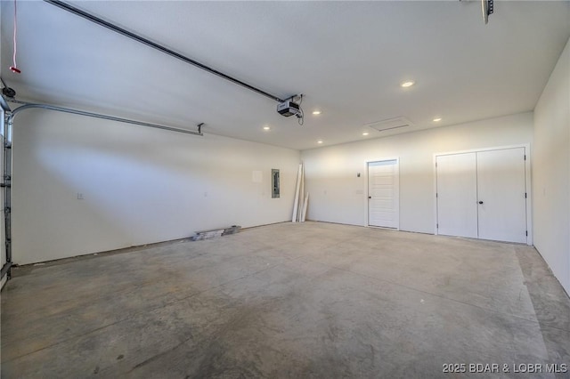 garage with electric panel and a garage door opener