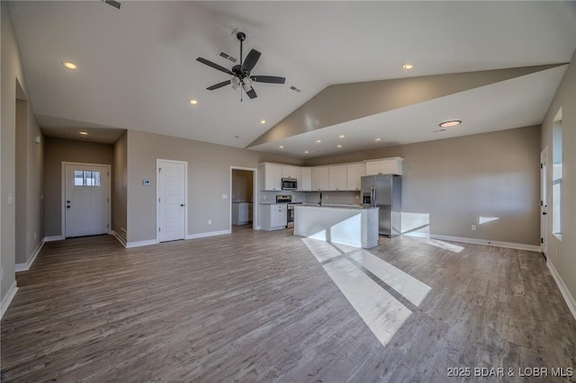 kitchen with white cabinets, appliances with stainless steel finishes, a center island, and light wood-type flooring