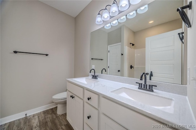 bathroom featuring vanity, hardwood / wood-style flooring, toilet, and walk in shower