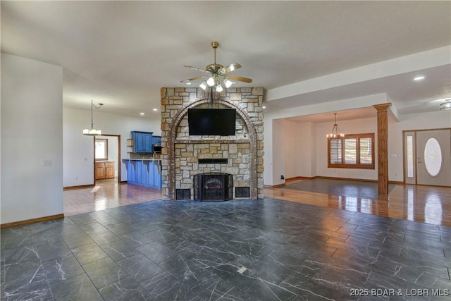 unfurnished living room with a stone fireplace and ceiling fan