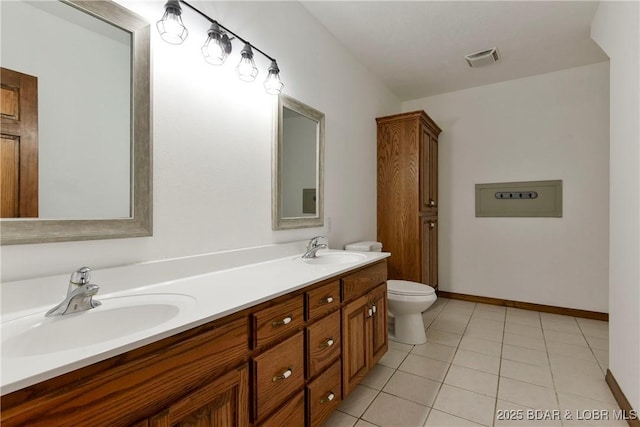 bathroom featuring tile patterned floors, vanity, and toilet