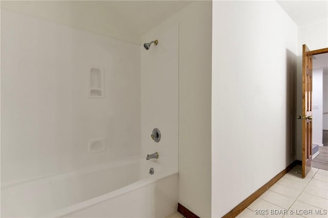 bathroom with tile patterned floors and shower / tub combination