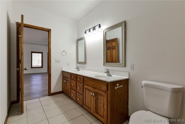 bathroom with tile patterned floors, vanity, and toilet