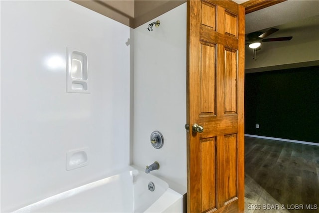 bathroom with ceiling fan, shower / bathing tub combination, and wood-type flooring