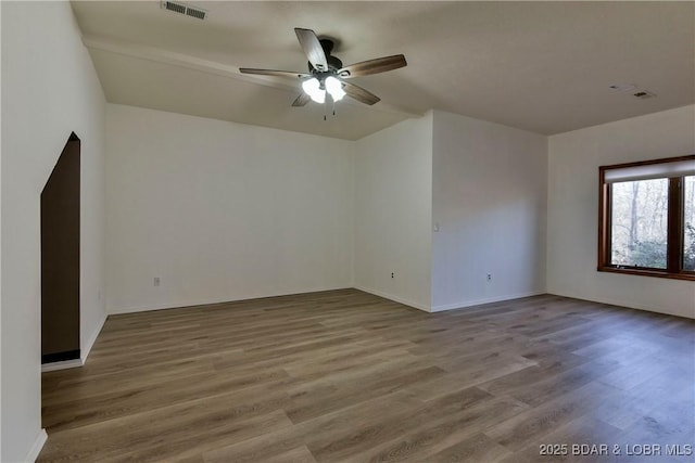 empty room featuring hardwood / wood-style flooring and ceiling fan