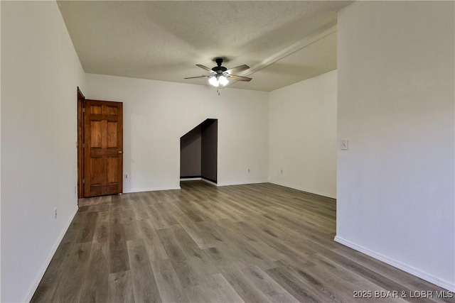 empty room featuring ceiling fan and light hardwood / wood-style floors