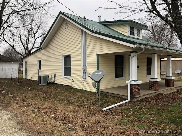 view of home's exterior featuring a porch and cooling unit