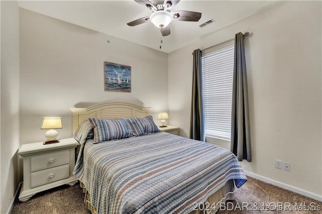 bedroom featuring multiple windows, ceiling fan, and dark carpet