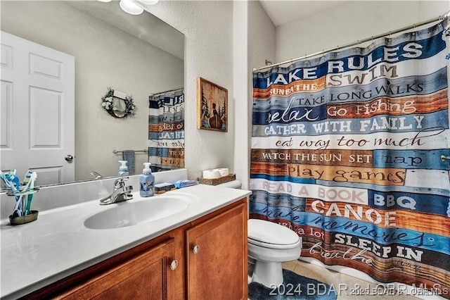 bathroom featuring tile patterned flooring, vanity, toilet, and a shower with shower curtain