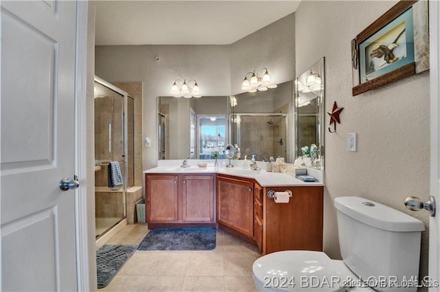 full bathroom with toilet, a textured wall, a stall shower, tile patterned flooring, and vanity