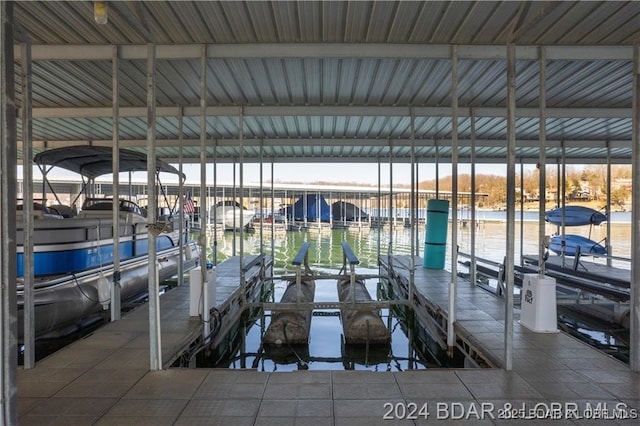 dock featuring boat lift and a water view