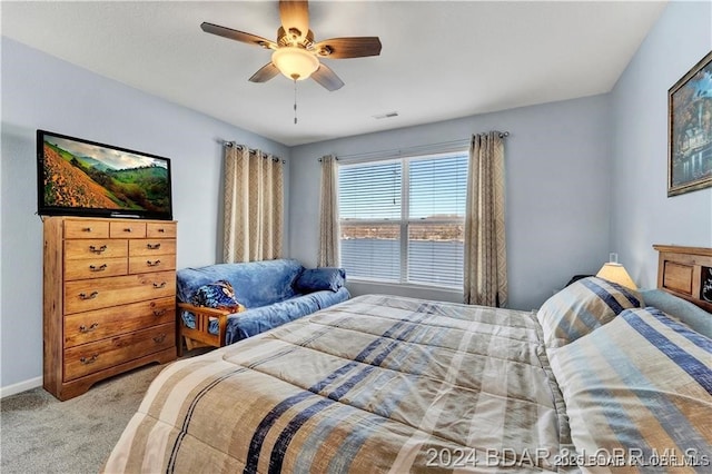 bedroom with light carpet and ceiling fan