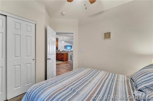 bedroom with ceiling fan and a closet