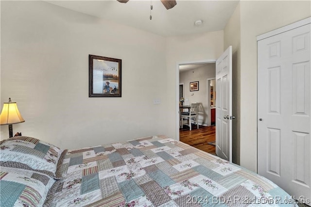 bedroom with dark hardwood / wood-style flooring and ceiling fan