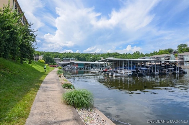 dock area featuring a water view and a yard